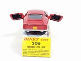 a red toy car sitting on top of a box