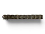 a close up of a metal object on a white surface