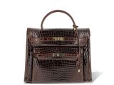 a brown crocodile skin handbag on a white background