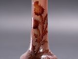 a small vase with a flower on it on a table