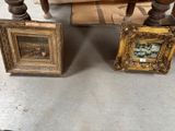 two picture frames sitting next to each other on the floor