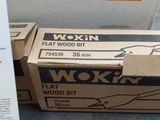a box of wood bits sitting on the floor next to a box of wood bits