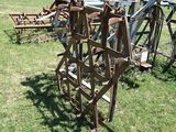 many old farm implements that are sitting in the grass