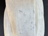 a close up of a white bowl on a black surface