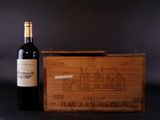 two bottles of red wine and a wooden box with a drawing of a house