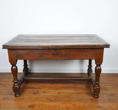 an old wooden table sitting on top of a hard wood floor