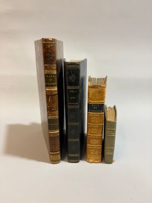three books are stacked on top of each other on a white surface