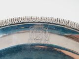 an image of a silver plate with a design on it
