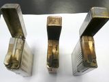 three lighters that are sitting on a table