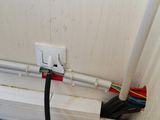 a white electrical outlet with wires attached to it
