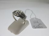 an image of a silver ring sitting on top of a white surface