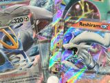 two pokemon cards sitting on top of each other on a table