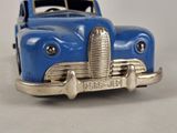 a blue toy car that is sitting on a table