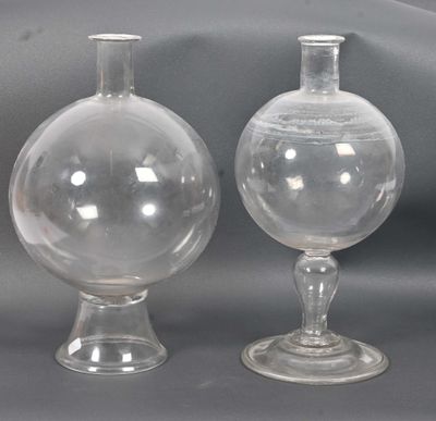 two glass vases sitting next to each other on a table