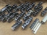 a lot of different types of train parts on the floor