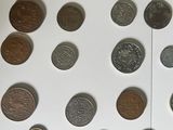 a lot of coins that are on a white surface