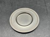 a silver plate sitting on top of a metal sink