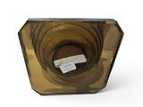 a glass vase that has a label on it