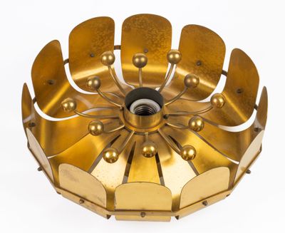 a gold plated ceiling light that has a flower design on it