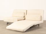 an image of a white chaise lounger sitting on top of a cement floor