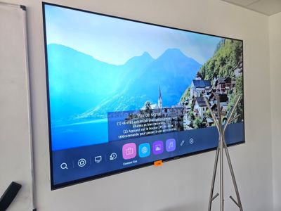 a flat screen tv hanging on the wall in a room