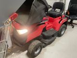 a red lawn mower parked in a garage