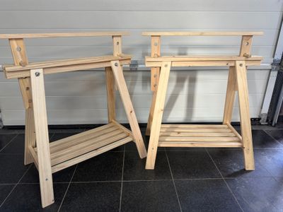 two wooden tables that are standing next to each other