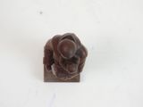 a figurine of a flower on a white surface