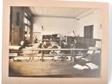 a black and white photo of a room with a bunch of people in it
