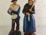 two figurines of people that are standing next to each other