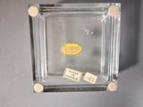 a small glass box with a label on it