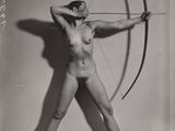 an old black and white photo of a naked woman holding a bow and arrow