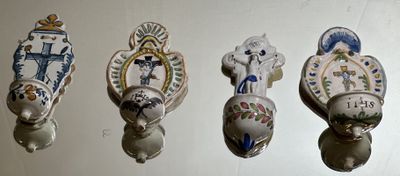 five different types of decorative wall hooks on the wall