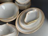a lot of plates and bowls that are sitting on a table