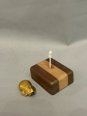 a small wooden box with a candle on top of it