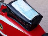 a red motorcycle with a gps device on the handlebars