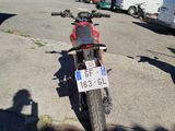 a motorcycle parked in a parking lot next to other vehicles