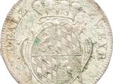 a close up of an old coin with a cross on it