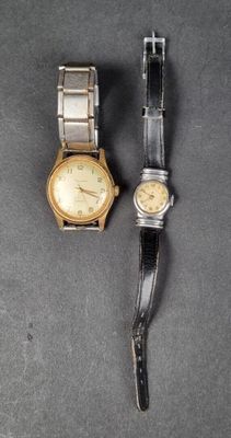 two watches that are sitting next to each other on a table