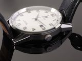 a close up of a watch on a black surface