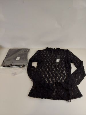 the shirt is black and has a lace pattern on it