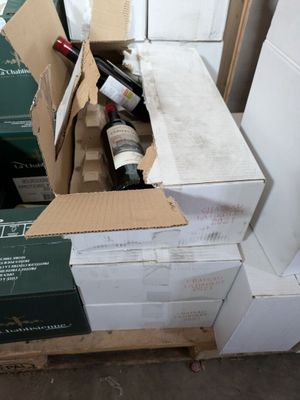 boxes of wine are stacked on top of each other on a pallet