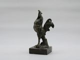 statue of a rooster on a marble base on a white background