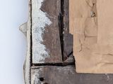 a picture of a piece of wood with a piece of paper sticking out of it