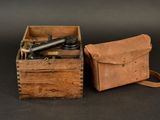 an old wooden box with a camera and a leather case