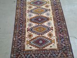 rug on the ground with a cat laying on top of it