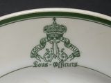 a green and white plate with a crown on it