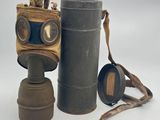 a gas mask and a pair of binoculars on a white background