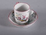 a cup and saucer with a bird design on it