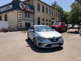 a white car parked in front of a building with cars parked in front of it
